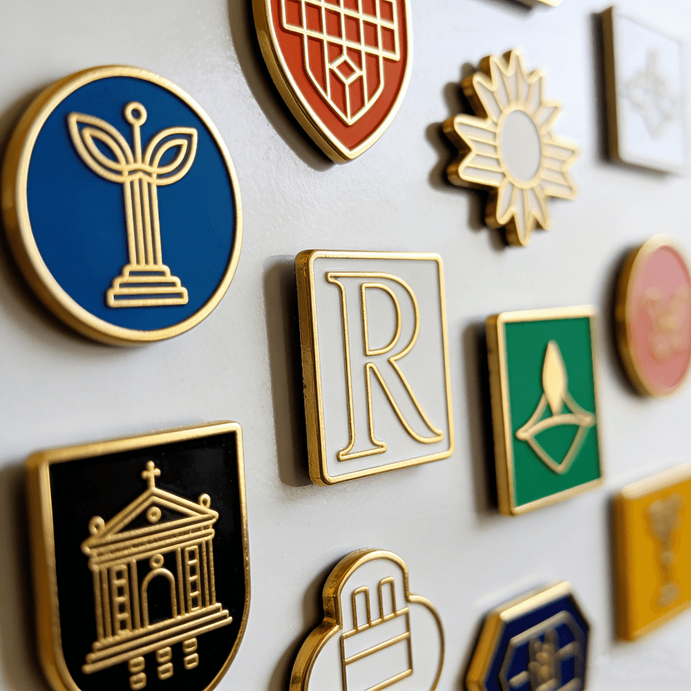 Collection of bespoke enamel fridge magnets on a display surface