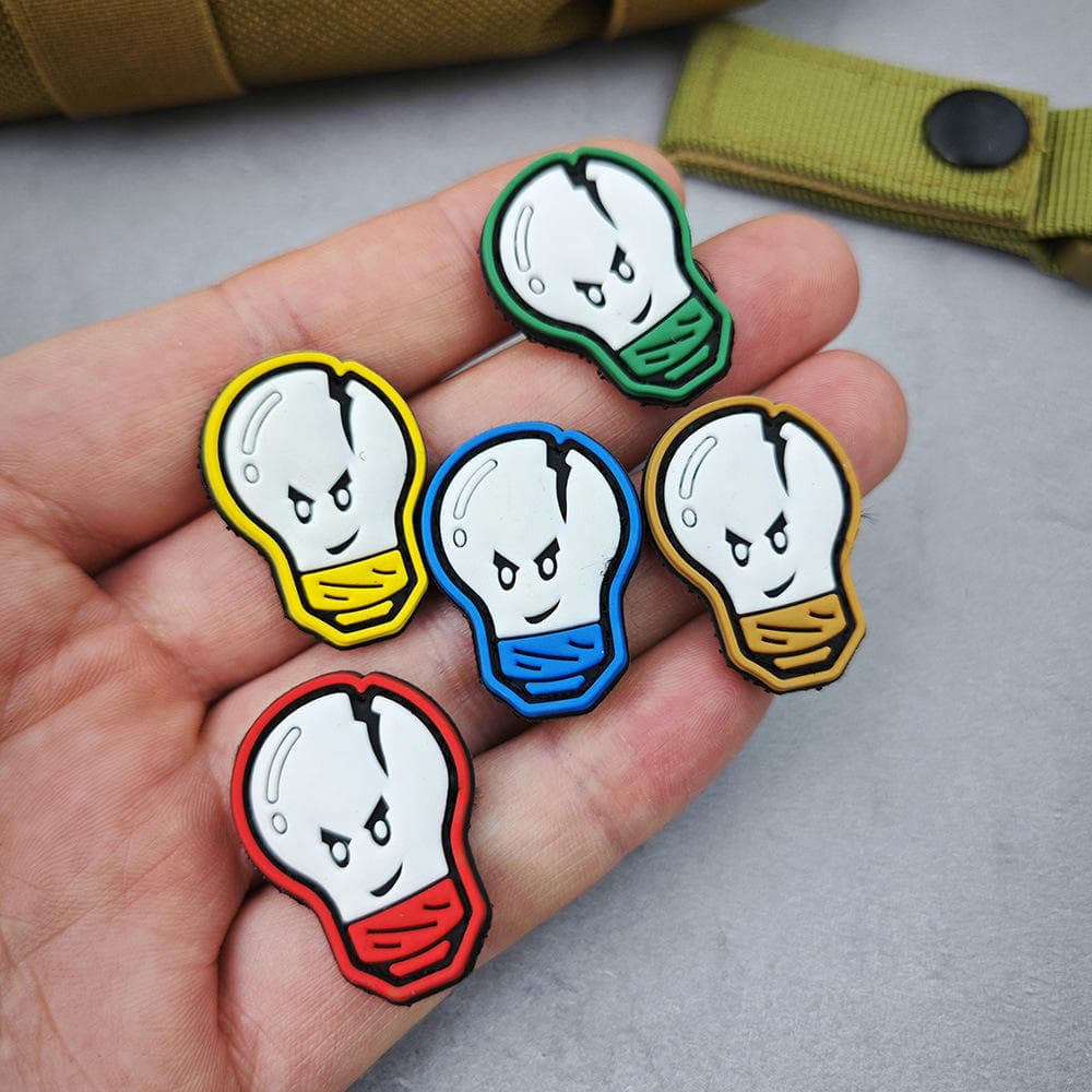 Custom PVC pin badges: colourful ghost badges in hand