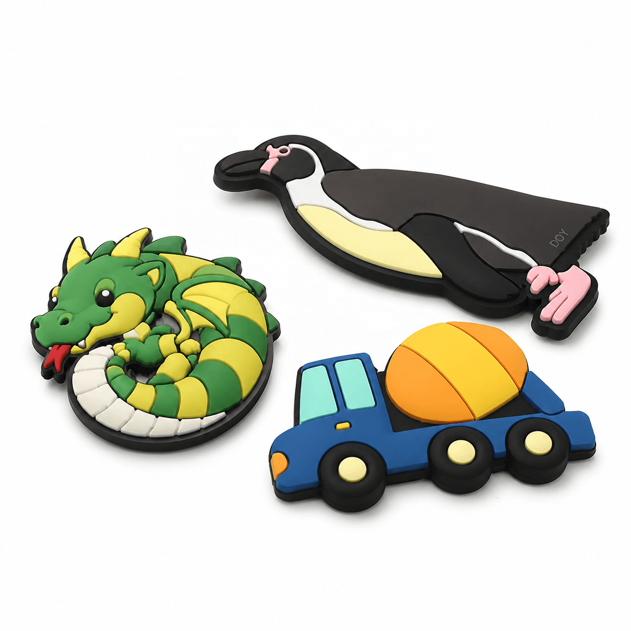 Collection of custom PVC fridge magnets including a dragon, dodo and truck