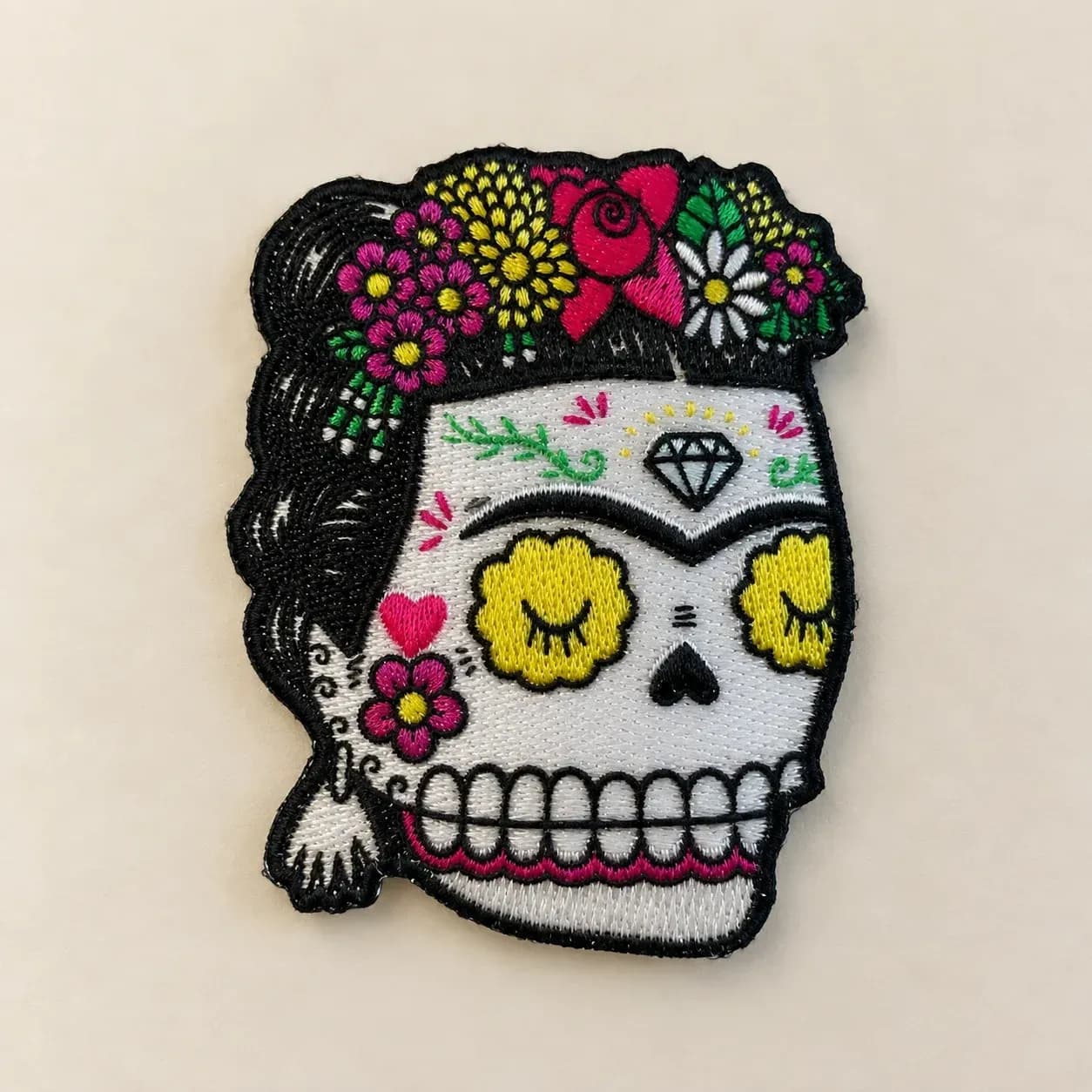 Colourful skull patch supplied as a woven example, with flowers and fine decorative details