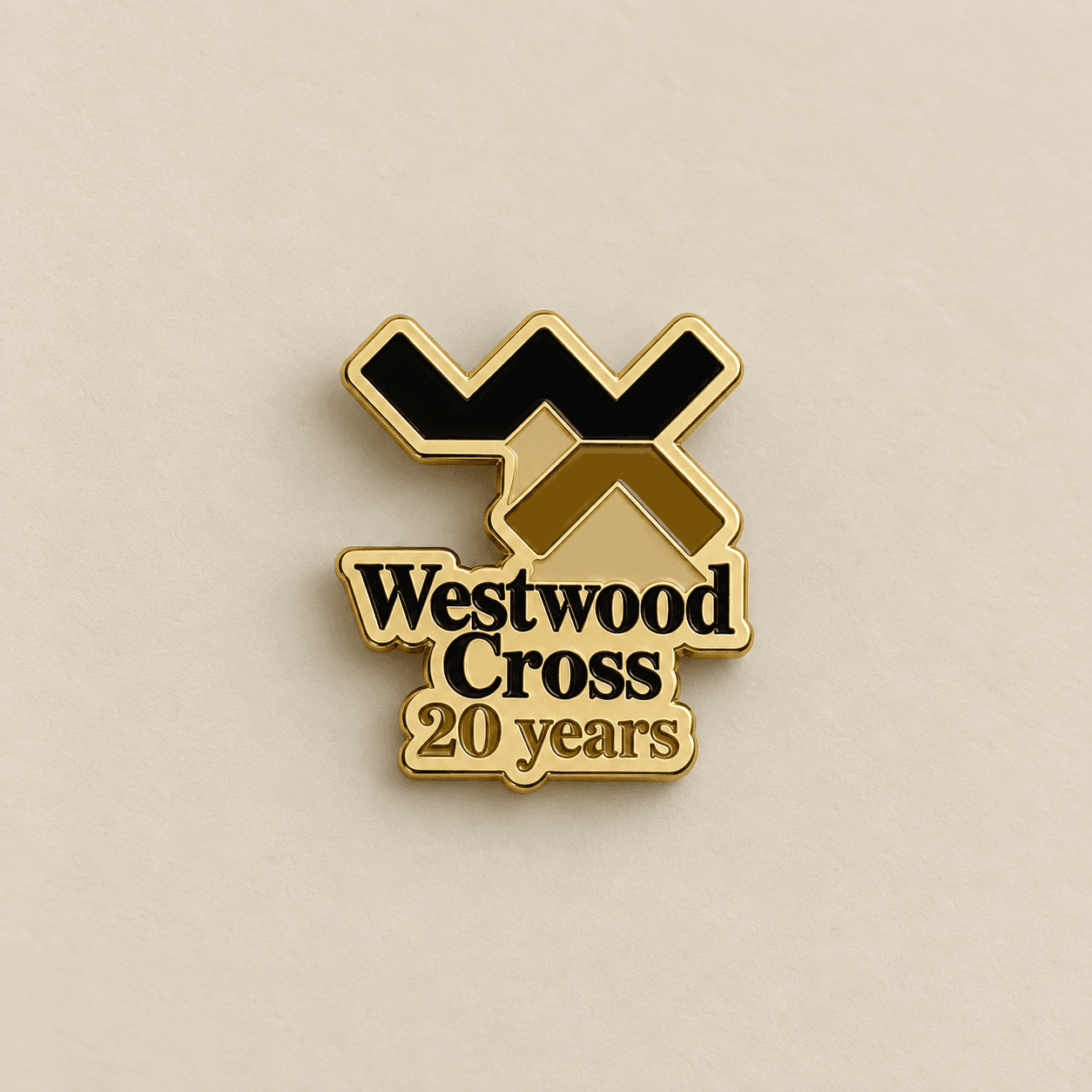 Gold and black Westwood Cross anniversary enamel badge