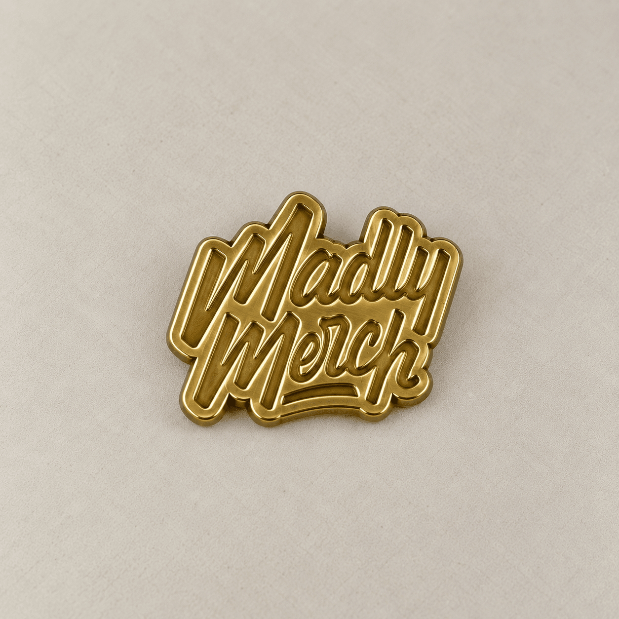 Brass-toned plated metal wordmark sample.
