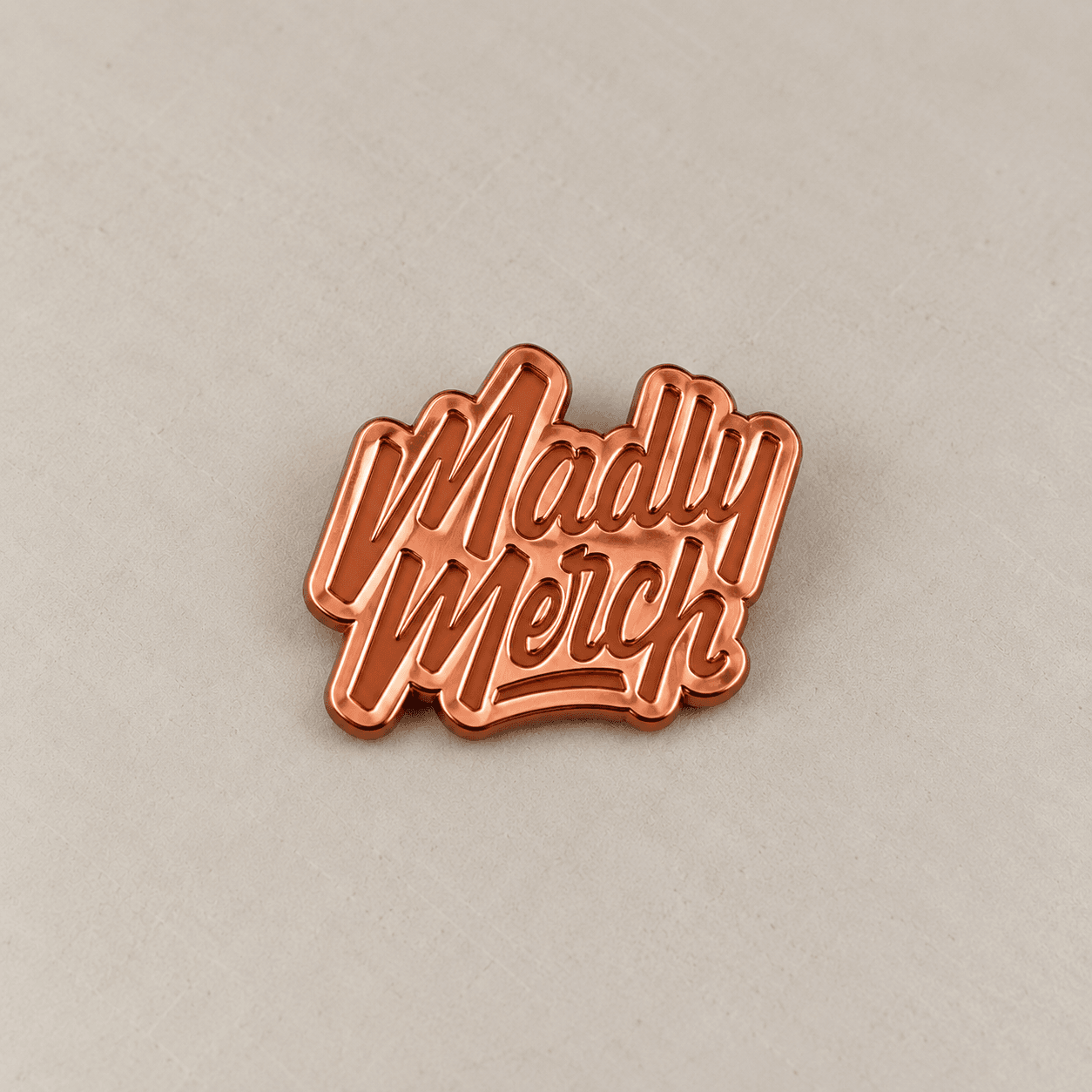 Copper-toned plated metal wordmark sample.