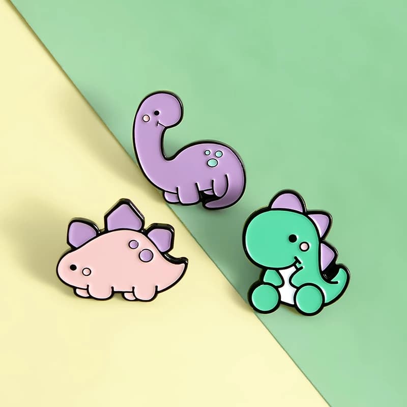 Soft enamel pin badges from the live page: dinosaur promotional badge