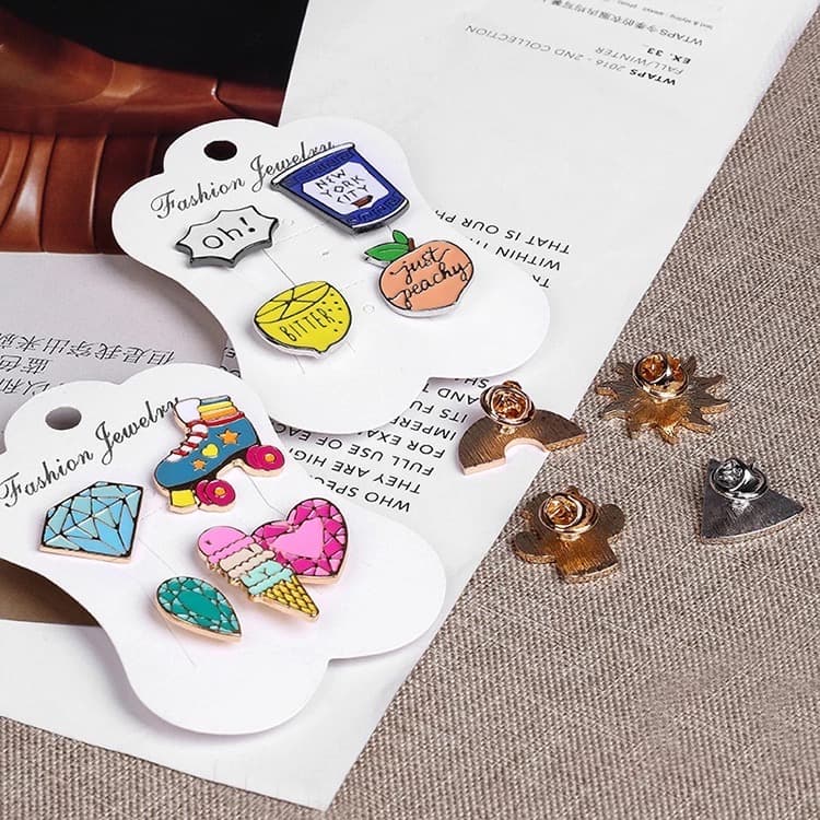 Soft enamel pin badges from the live page: badge front and back