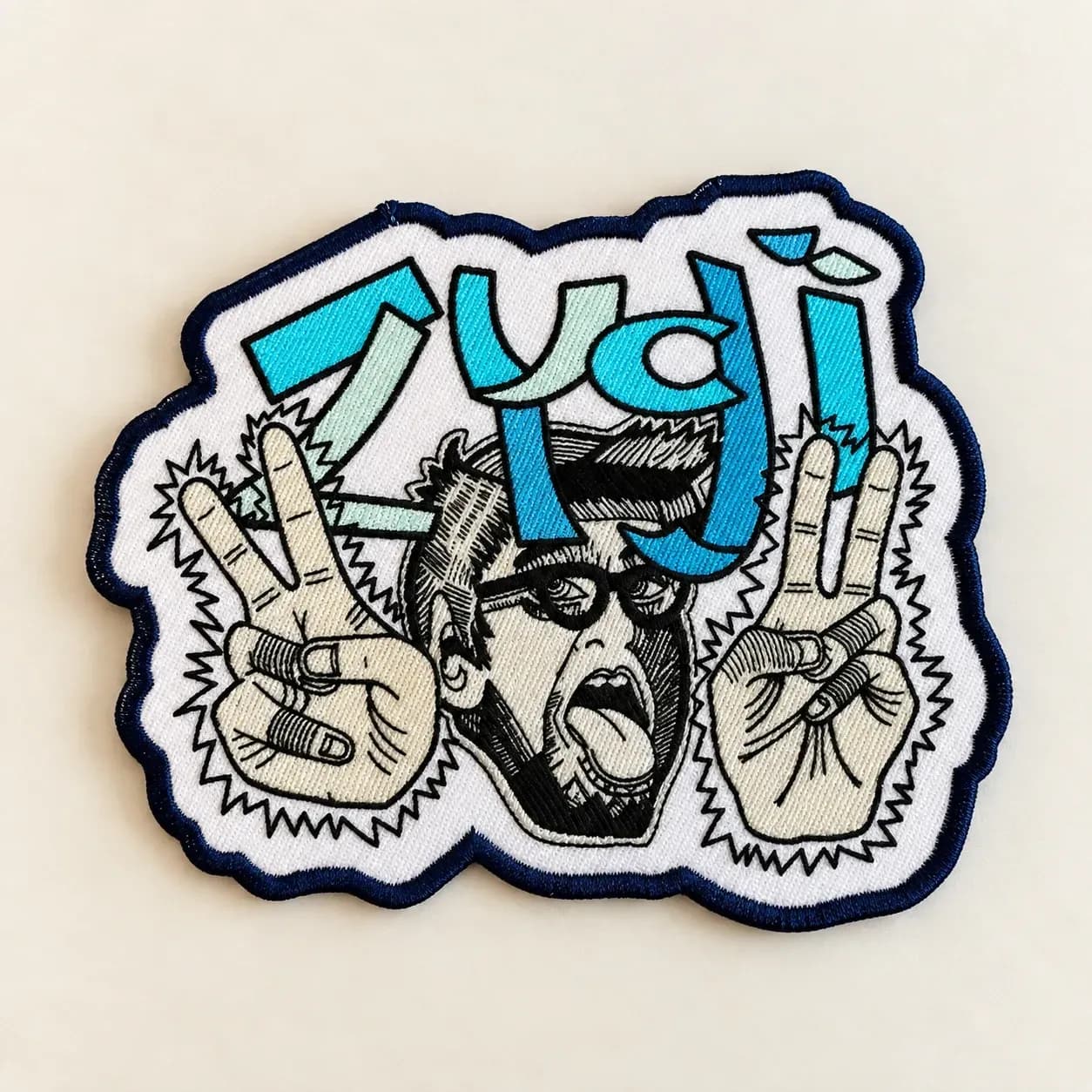 Woven illustrated character patch with fine black outlines and turquoise lettering