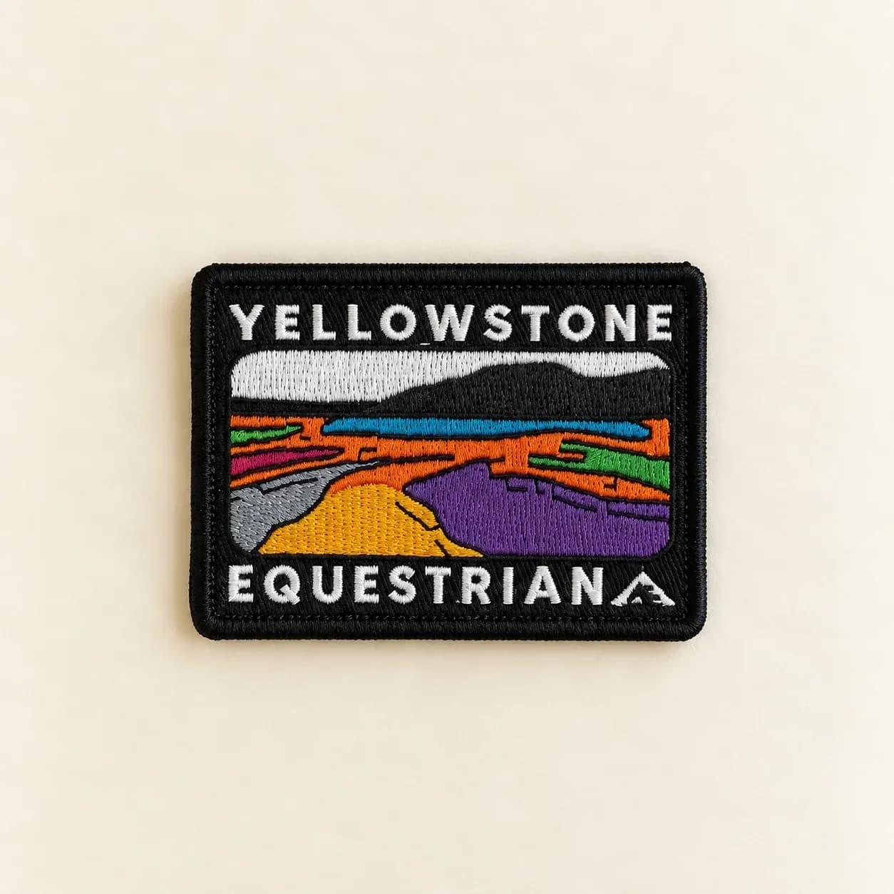 Embroidered Yellowstone Equestrian patch with white lettering and a colourful stitched landscape