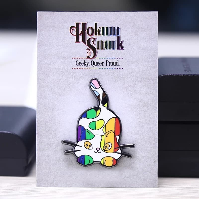 Hard enamel pin badges from the live page: badge card display