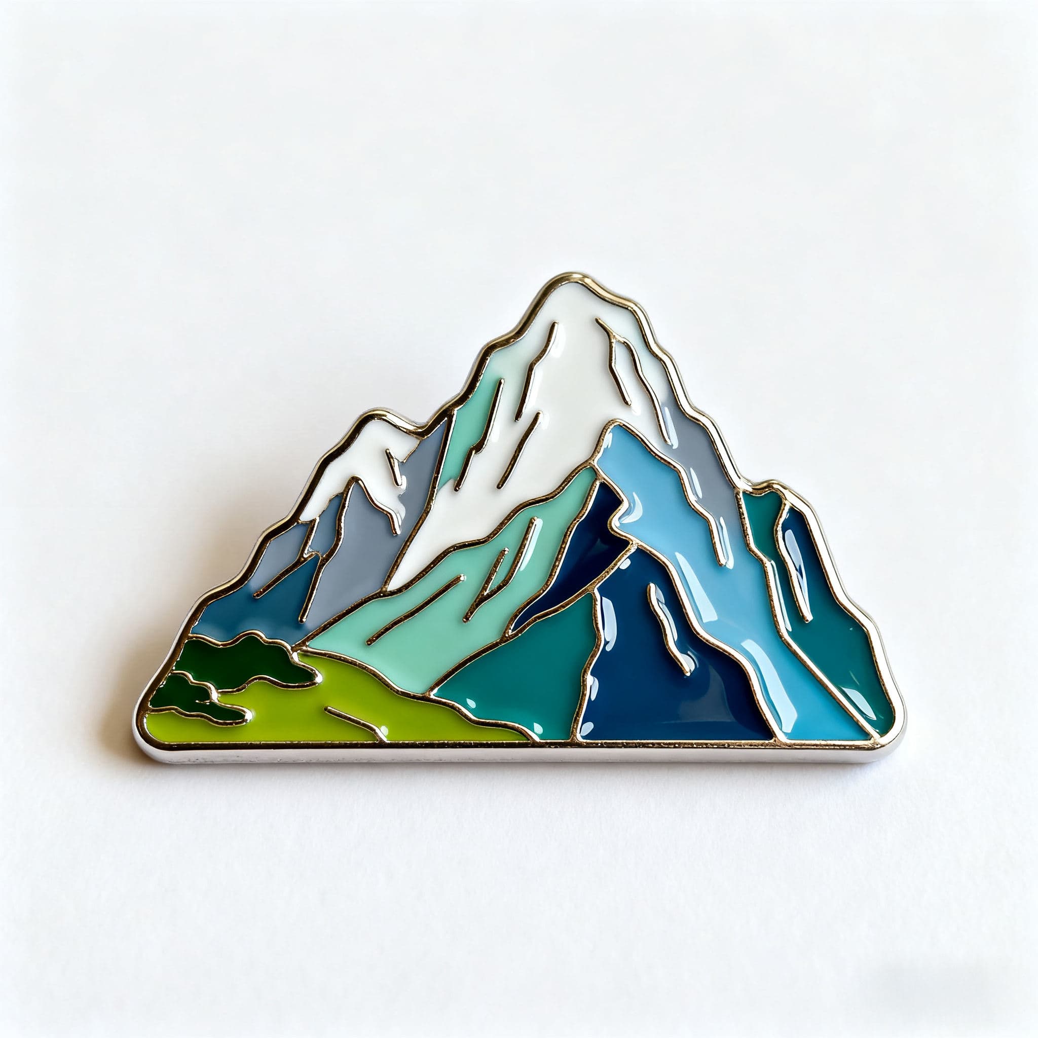 Mountain-shaped enamel fridge magnet with blue and green details