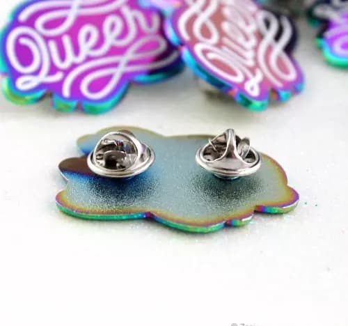 Rainbow plated pin badges from the live page: pin backing