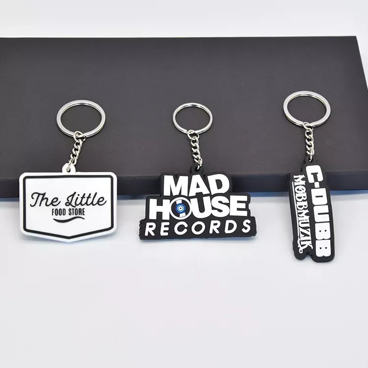 PVC rubber keyrings from the live page: white and black rubber keyrings