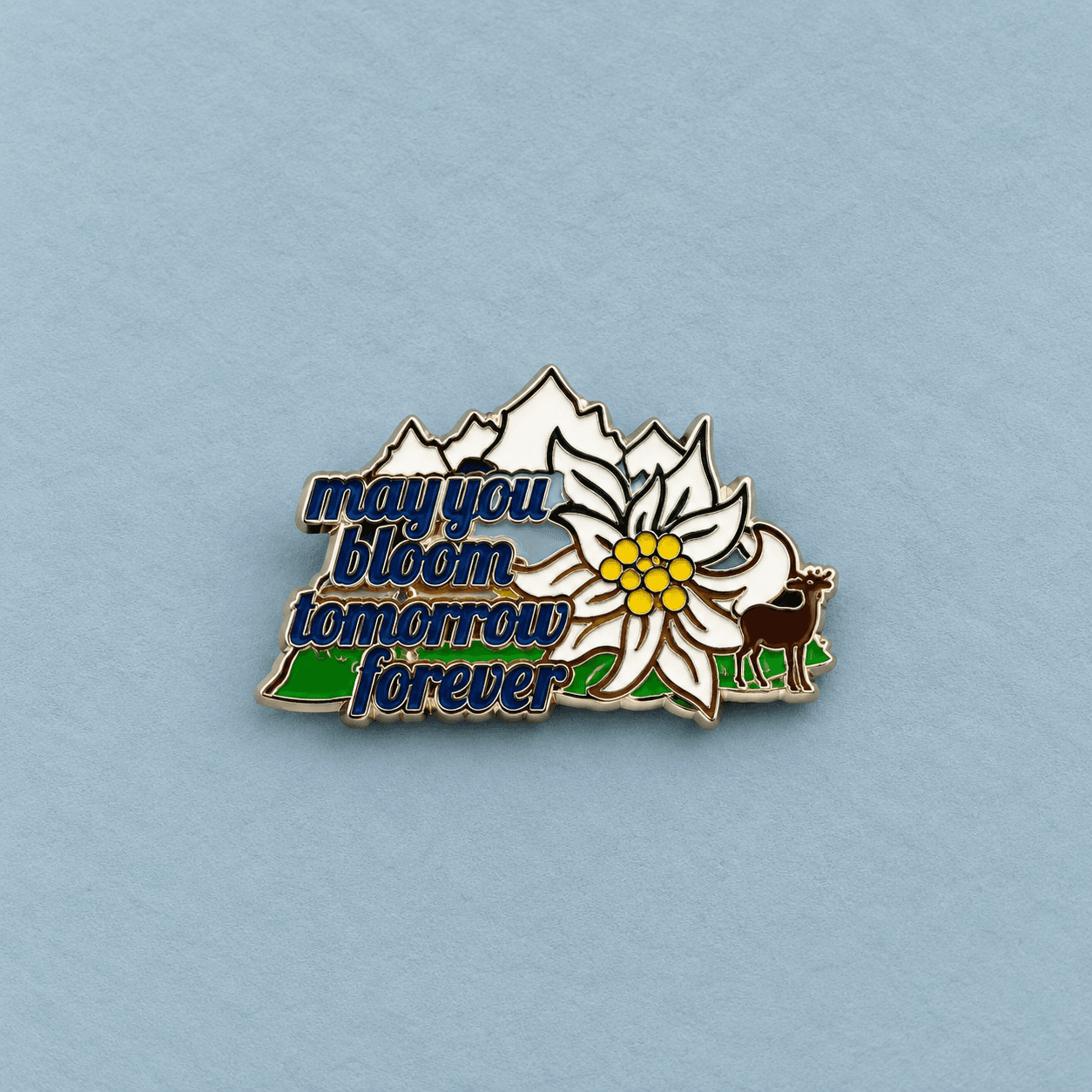 Flower and deer enamel badge with blue background